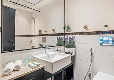 a bathroom with a sink and a mirror at Two Bedroom Apartment at JBR with Marina and Bluewaters Views in Dubai