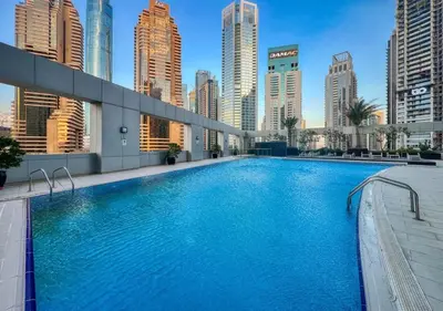 a large swimming pool in a city with tall buildings at Two Bedroom Apartment at JBR with Marina and Bluewaters Views in Dubai