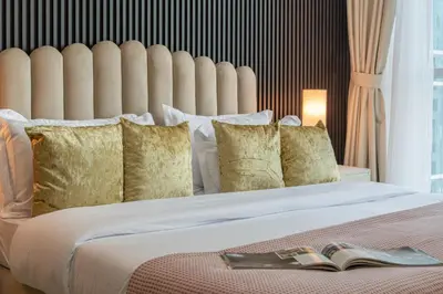 a bedroom with a large bed with a book on it at Stylish Large 2BR Apartment in the Heart of Dubai Marina in Dubai