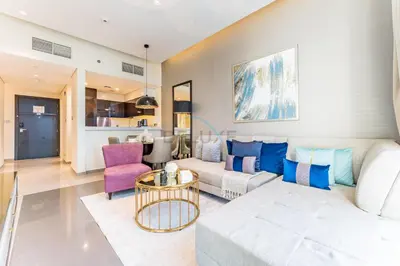 a living room with a couch and a table at Chic 2BR Apartment, Near Dubai Mall and Fountain - Damac Majestine, Business Bay by Deluxe Holiday Homes in Dubai