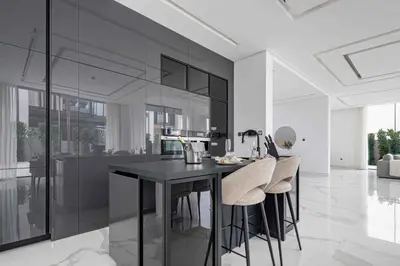 a kitchen with a black counter and stools at Frank Porter - Villa La Mer, Jumeirah 1 in Dubai