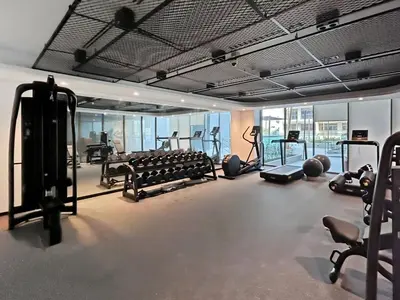 a gym with lots of treadmills and exercise bikes at Brand New 1BR Apartment In Amalia Residences Al Furjan in Dubai