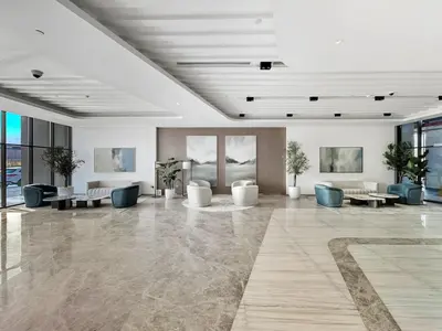 a lobby with couches and tables in a building at Brand New 1BR Apartment In Amalia Residences Al Furjan in Dubai