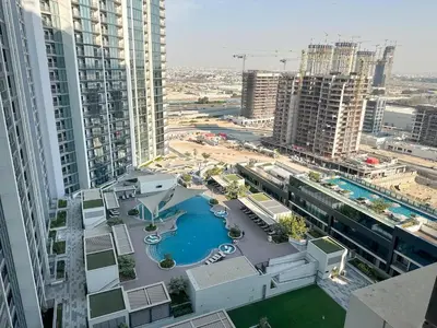 an aerial view of a swimming pool in a city at Stylish & Cozy Fully Furnished 2BR plus Maid Crest C in Dubai