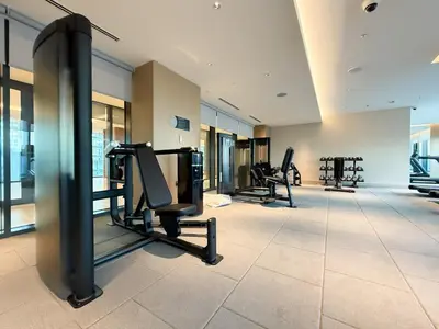 a gym with treadmills and ellipticals in a building at Stylish & Cozy Fully Furnished 2BR plus Maid Crest C in Dubai