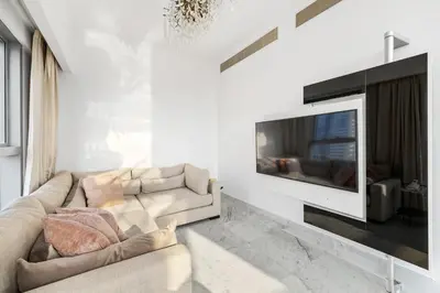 a living room with a couch and a television at 2BR Duplex DIFC Near Museum of the Future in Dubai