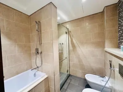 a bathroom with a shower and a toilet and a sink at Greens Community View Spacious 1BR Fully Furnished in Dubai