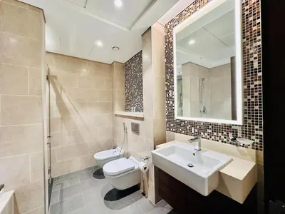 a bathroom with a sink and a toilet and a mirror at Greens Community View Spacious 1BR Fully Furnished in Dubai