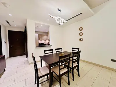 a dining room with a table and chairs at Greens Community View Spacious 1BR Fully Furnished in Dubai