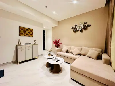 a living room with a couch and a table at Brand New 1BR in Creek Vista Grande in Dubai