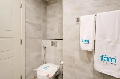 a bathroom with a toilet and towels on the wall at Elegant 1BR in Polo Residences Nad Al Sheba in Dubai