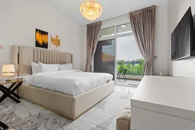 a bedroom with a large bed and a large window at Stylish Pool-View Studio w Balcony & King Bed in Dubai