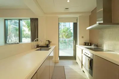 a large kitchen with a sink and a stove at Stylish 2BR Paramount Tower D in Dubai