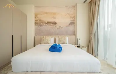 a white bed with a blue stuffed animal on it at New Arabian Palm Hills 6BR & Maid & Private Pool in Dubai