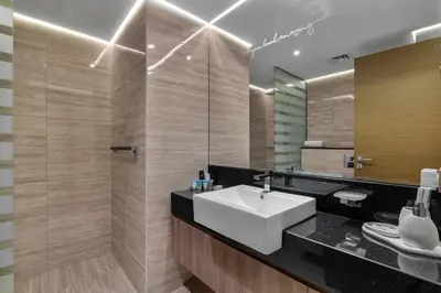 a bathroom with a sink and a mirror at Stylish Missoni Studio With Direct Pool Access in Dubai