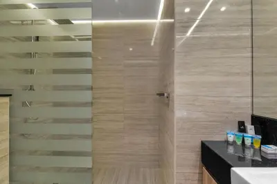 a bathroom with a shower with a glass door at Stylish Missoni Studio With Direct Pool Access in Dubai