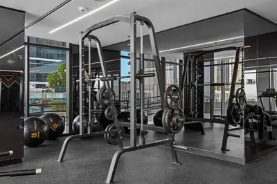 a gym with a lot of weights and balls at Stylish Missoni Studio With Direct Pool Access in Dubai