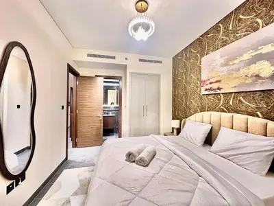 a bedroom with a large bed and a mirror at Modern Fully Furnished 1BR plus Study in Crest Tower B in Dubai