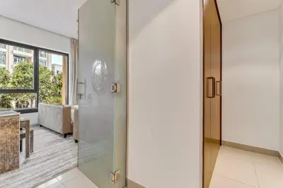 a glass door leading to a living room at GuestReady - Downtown stay | 29 Boulevard in Dubai