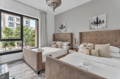 a bedroom with two beds and a couch at GuestReady - Downtown stay | 29 Boulevard in Dubai