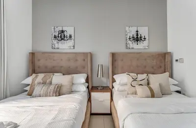 two beds sitting next to each other in a bedroom at GuestReady - Downtown stay | 29 Boulevard in Dubai