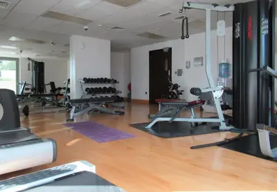 a gym with several exercise equipment in a room at GuestReady - Downtown stay | 29 Boulevard in Dubai