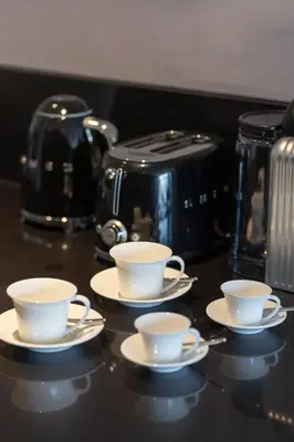 three coffee cups and saucers sitting on a counter at The Opus Residences Luxury Design in Dubai