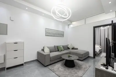 a living room with a couch and a table at Dubai Marina - Comfy 1BHK Apartment in Dubai