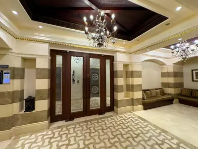 a large room with a chandelier and a couch at Werova - Spacious 1-Bedroom Apartment for Rent in Dubai