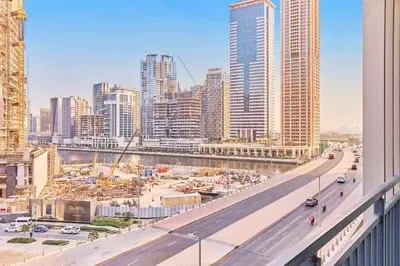 a view of a city with a highway and buildings at Compact 1 BHK Apartment in Dubai