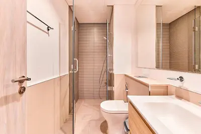 a bathroom with a toilet and a sink and a shower at Compact 1 BHK Apartment in Dubai