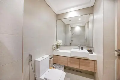 a bathroom with a toilet and a sink at Livin' Holidays -Studio - Azizi Magnificent Studio in Dubai