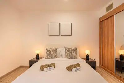 a bedroom with a large bed with two lamps at Central Spacious Marina Home on the 64th Floor in Dubai