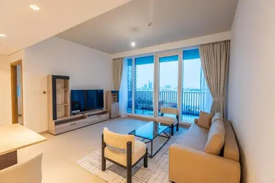 a living room with a couch and a large window at 1BR Lake & Harbour View Dubai Creek Harbour in Dubai