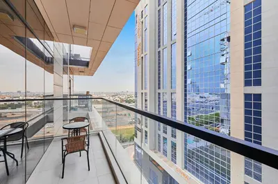 a balcony with tables and chairs in a building at Bright 2 BHK in Prime Location in Dubai