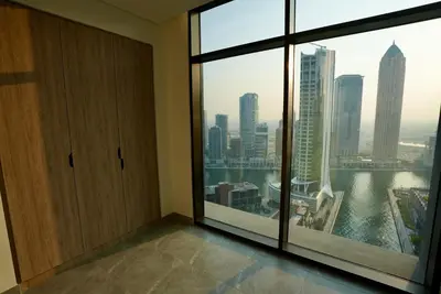 a room with a large window with a view of a city at Elegant 1BHK Sea View Apartment City View in Dubai
