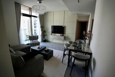 a living room with a couch and a table at Elegant 1BHK Sea View Apartment City View in Dubai