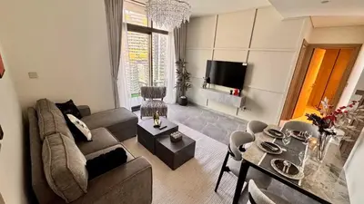a living room with a couch and a table at Elegant 1BHK Sea View Apartment City View in Dubai