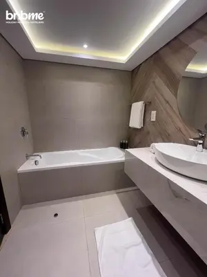 a bathroom with a bath tub and a sink at bnbmehomes - Burj Views East Tower in Dubai