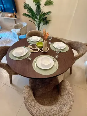 a dining room table with chairs and a table with plates at Elite Downtown 1BR Stylish 1BR in Dubai
