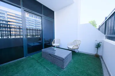 a balcony with two chairs and a table on a building at Premium Studio near Meydan Azizi Riviera 46 in Dubai