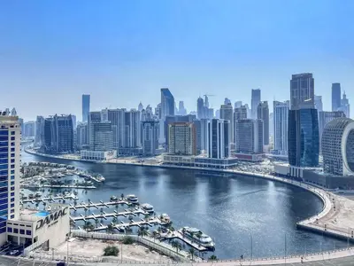 a view of a river with boats in a city at GuestReady – Business Bay Bliss | Near Dubai Mall in Dubai