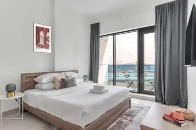 a bedroom with a large bed and a large window at GuestReady – Business Bay Bliss | Near Dubai Mall in Dubai