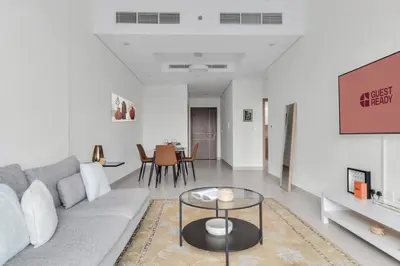 a living room with a couch and a table at GuestReady – Business Bay Bliss | Near Dubai Mall in Dubai