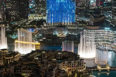 an aerial view of a city at night at Elite Burj Khalifa Fountain 4 BR Flat in Dubai