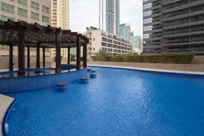 a large swimming pool in a city with tall buildings at Marcopolo - Relaxing 1BR in Dubai Marina with Huge Balcony in Dubai