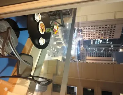 a glass window with a view of a building at Dubai Short Stay Vacation Homes Rental Room in Dubai