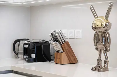 a kitchen with a robot standing next to a coffee maker at Serene Waterfront Gem UPSCALE in Dubai