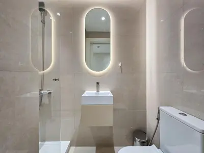a bathroom with a toilet and a sink and a mirror at Marina Residence 5, Palm Jumeirah - Mint Stay in Dubai