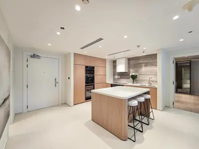 a kitchen with a counter and stools in it at Marina Residence 5, Palm Jumeirah - Mint Stay in Dubai